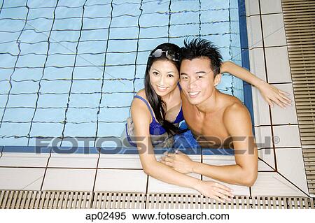 Couple in swimming pool corner, looking up at camera View Large Photo Image Stock Photography - Couple in swimming pool corner, looking up at camera. Fotosearch