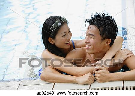 Couple in swimming pool, embracing View Large Photo Image Stock Photo - Couple in swimming pool, embracing. Fotosearch