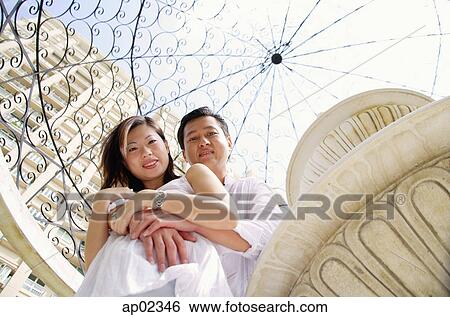 Couple looking at down camera View Large Photo Image Stock Photograph - Couple looking at down camera . Fotosearch