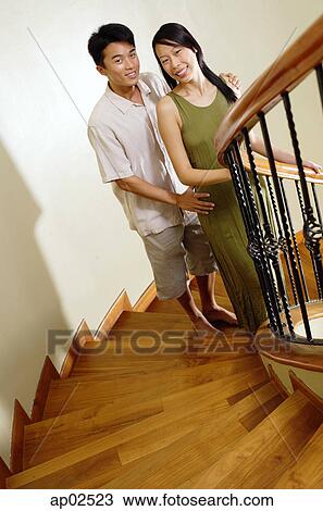 Couple on staircase, smiling at camera View Large Photo Image Stock Image - Couple on staircase, smiling at camera . Fotosearch