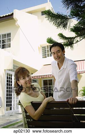 Couple outdoor, looking at camera, smiling View Large Photo Image Stock Image - Couple outdoor, looking at camera, smiling . Fotosearch
