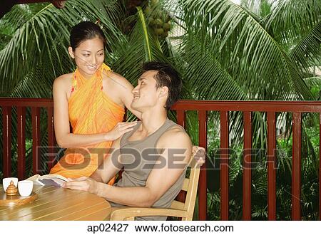 Couple sitting at patio View Large Photo Image Stock Photo - Couple sitting at patio . Fotosearch