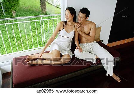 Couple sitting on daybed next to window View Large Photo Image Stock Photography - Couple sitting on daybed next to window. Fotosearch