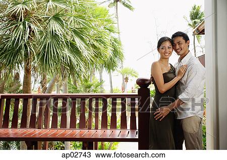 Couple standing cheek to cheek, embracing, smiling View Large Photo Image Stock Image - Couple standing cheek to cheek, embracing, smiling . Fotosearch