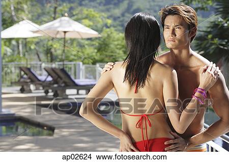 Couple standing face to face, man looking over shoulder of woman, rear view View Large Photo Image Picture - Couple standing face to face, man looking over shoulder of woman, rear view . Fotosearch