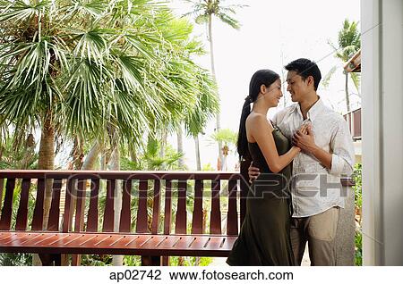 Couple standing face to face, embracing, holding hands View Large Photo Image Stock Image - Couple standing face to face, embracing, holding hands . Fotosearch