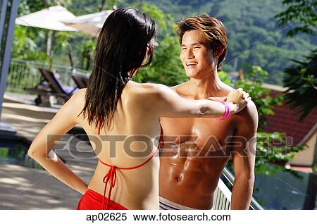 Couple standing face to face, woman with hand on mans shoulder View Large Photo Image Stock Photography - Couple standing face to face, woman with hand on mans shoulder . Fotosearch