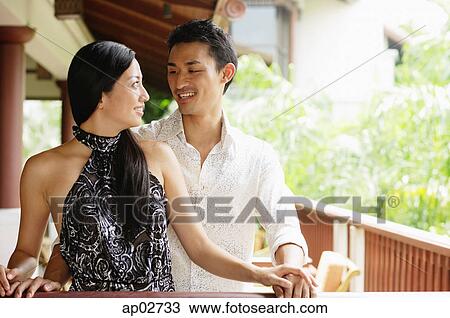 Couple standing, looking at each other View Large Photo Image Stock Image - Couple standing, looking at each other . Fotosearch