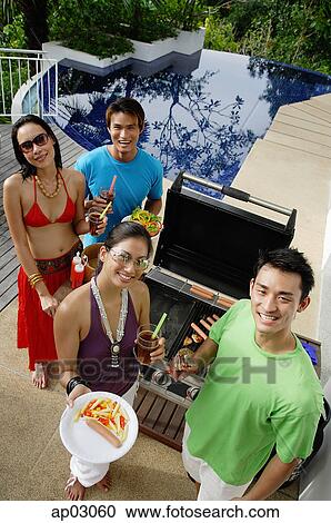 Couples at barbeque party, smiling at camera, portrait View Large Photo Image Stock Image - Couples at barbeque party, smiling at camera, portrait . Fotosearch