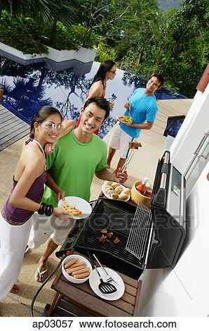 Couples at barbeque party View Large Photo Image Stock Photo - Couples at barbeque party . Fotosearch
