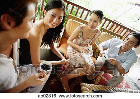 Couples sitting together, having coffee and talking View Large Photo Image Stock Photograph - Couples sitting together, having coffee and talking . Fotosearch