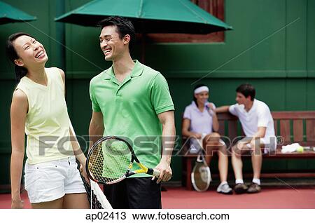 Couples spending time together on tennis court, laughing View Large Photo Image Stock Image - Couples spending time together on tennis court, laughing . Fotosearch