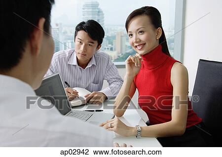 Executives having a discussion, woman smiling View Large Photo Image Stock Image - Executives having a discussion, woman smiling. Fotosearch