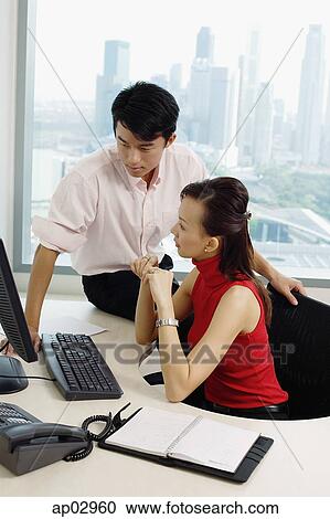 Executives in office looking at computer View Large Photo Image Stock Image - Executives in office looking at computer. Fotosearch