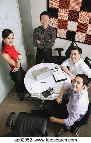 Executives looking up at camera View Large Photo Image Stock Image - Executives looking up at camera . Fotosearch