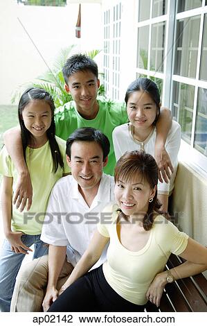 Family looking at camera and smiling View Large Photo Image Stock Image - Family looking at camera and smiling . Fotosearch
