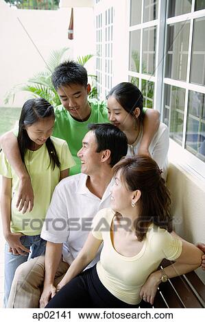 Family looking at each other and smiling View Large Photo Image Stock Image - Family looking at each other and smiling . Fotosearch
