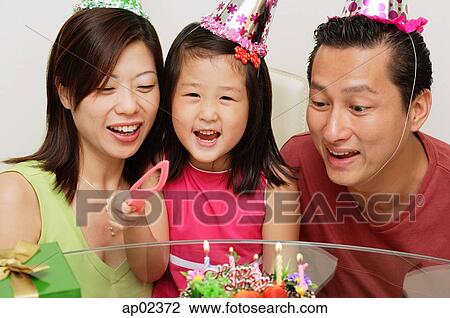 Stock Image - Family with one child celebrating a birthday. Fotosearch