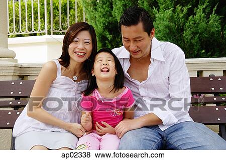 Family with one child, sitting on bench View Large Photo Image Stock Photo - Family with one child, sitting on bench . Fotosearch