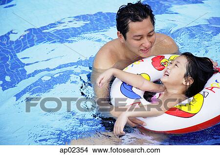 Father and daughter in swimming pool View Large Photo Image Picture - Father and daughter in swimming pool. Fotosearch
