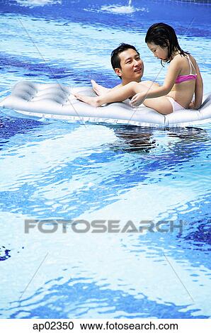 Father and daughter in swimming pool, daughter on inflatable raft View Large Photo Image Stock Image - Father and daughter in swimming pool, daughter on inflatable raft . Fotosearch