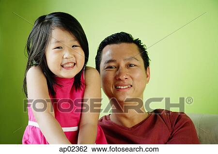 Stock Image - Father and daughter, side by side, smiling . Fotosearch