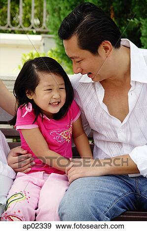 Father with one child, sitting on bench View Large Photo Image Stock Photo - Father with one child, sitting on bench . Fotosearch