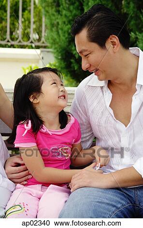 Father with one child, sitting on bench, looking at each other View Large Photo Image Stock Image - Father with one child, sitting on bench, looking at each other . Fotosearch