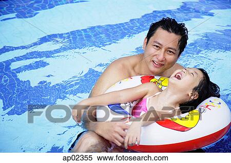 Stock Photography - Father with one daughter in swimming pool . Fotosearch