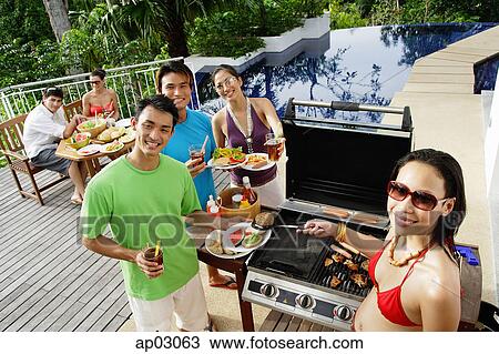 Friends at barbeque party, smiling at camera View Large Photo Image Stock Image - Friends at barbeque party, smiling at camera . Fotosearch