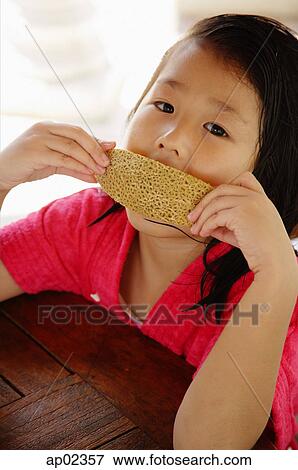 Girl eating bread View Large Photo Image Stock Photo - Girl eating bread . Fotosearch