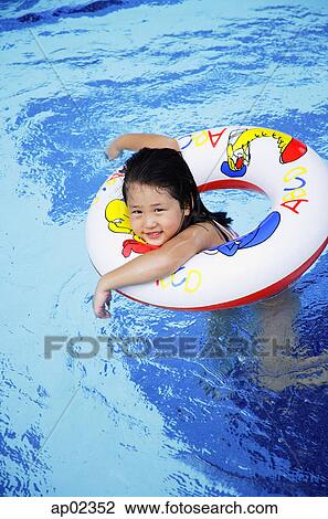 Girl in swimming pool using inflatable ring View Large Photo Image Stock Image - Girl in swimming pool using inflatable ring. Fotosearch