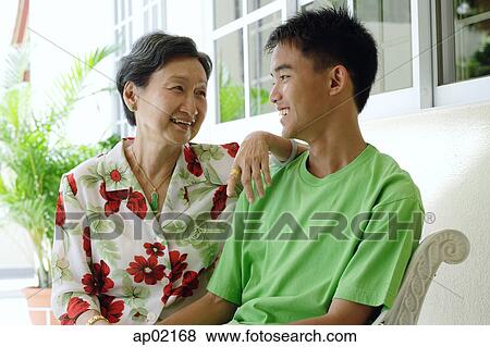 Grandmother and grandson looking at each other smiling View Large Photo Image Stock Photo - Grandmother and grandson looking at each other smiling . Fotosearch
