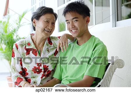 Grandmother sitting with grandson, side by side View Large Photo Image Stock Photo - Grandmother sitting with grandson, side by side . Fotosearch