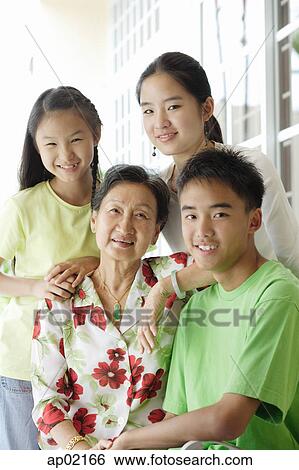 Grandmother sitting with her grandchildren View Large Photo Image Stock Photograph - Grandmother sitting with her grandchildren . Fotosearch