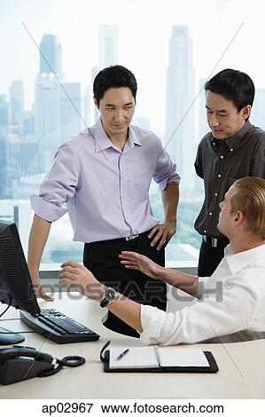 Male executives in office, having a discussion View Large Photo Image Stock Photo - Male executives in office, having a discussion. Fotosearch