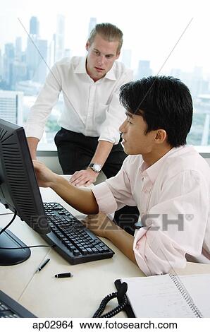 Male executives in office, looking at computer View Large Photo Image Picture - Male executives in office, looking at computer. Fotosearch