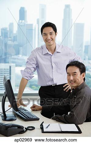 Male executives in office, smiling at camera View Large Photo Image Stock Photo - Male executives in office, smiling at camera. Fotosearch