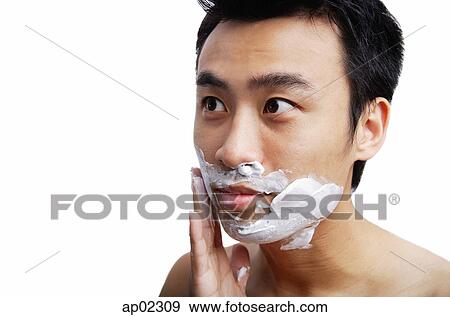Stock Photo - Man applying shaving cream to face . Fotosearch