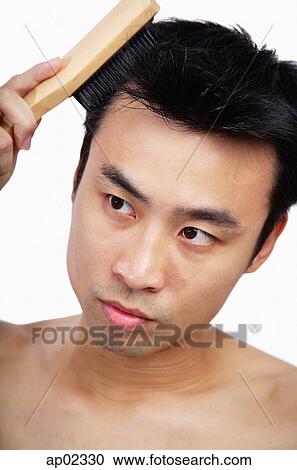 Man brushing his hair View Large Photo Image Stock Image - Man brushing his hair . Fotosearch