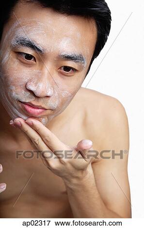 Man cleansing face View Large Photo Image Stock Photo - Man cleansing face . Fotosearch