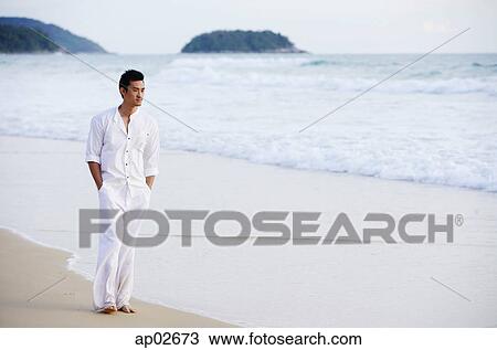 Man on beach, hands in pocket View Large Photo Image Stock Image - Man on beach, hands in pocket . Fotosearch
