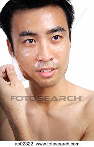 Man pulling facial mask off face View Large Photo Image Stock Image - Man pulling facial mask off face . Fotosearch