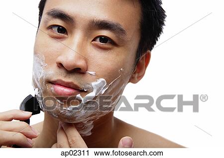 Man shaving face, looking at camera View Large Photo Image Stock Image - Man shaving face, looking at camera . Fotosearch