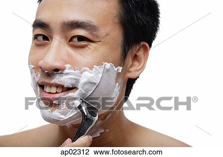 Man shaving face, looking at camera, smiling View Large Photo Image Stock Image - Man shaving face, looking at camera, smiling . Fotosearch
