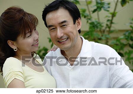 Man smiling at camera, woman smiling at man View Large Photo Image Stock Photography - Man smiling at camera, woman smiling at man. Fotosearch