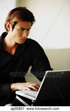 Man using laptop View Large Photo Image Stock Image - Man using laptop . Fotosearch