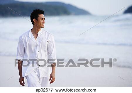 Man walking on beach View Large Photo Image Stock Photo - Man walking on beach. Fotosearch