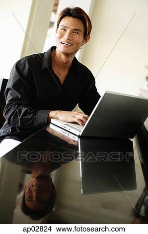 Man with laptop, looking away View Large Photo Image Picture - Man with laptop, looking away . Fotosearch