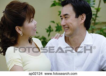 Mature couple side by side, smiling at each other View Large Photo Image Picture - Mature couple side by side, smiling at each other . Fotosearch